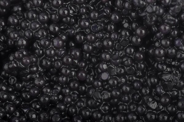 Delicious black caviar in bulk on the whole screen