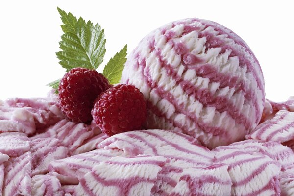 A ball of ice cream with raspberries in macro photography