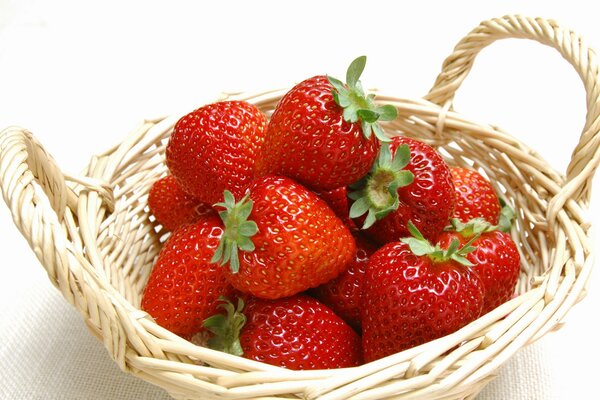 Cesto con fragole su sfondo bianco