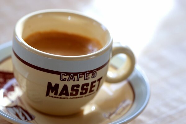 A cup with an inscription filled with fragrant coffee