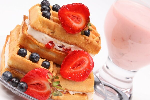 Sweet dessert with strawberries, blackberries and cream