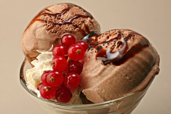 Chocolate ice cream with red currant in a glass