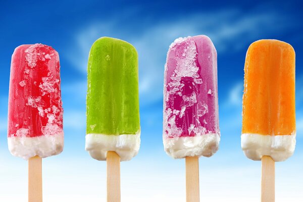 Multicolored popsicle on the sky background