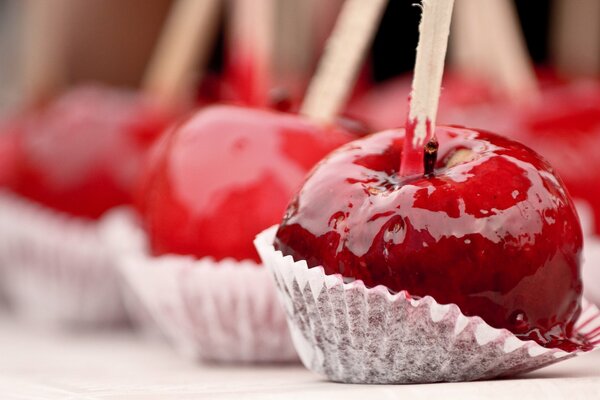 Red apples in caramel on a stick