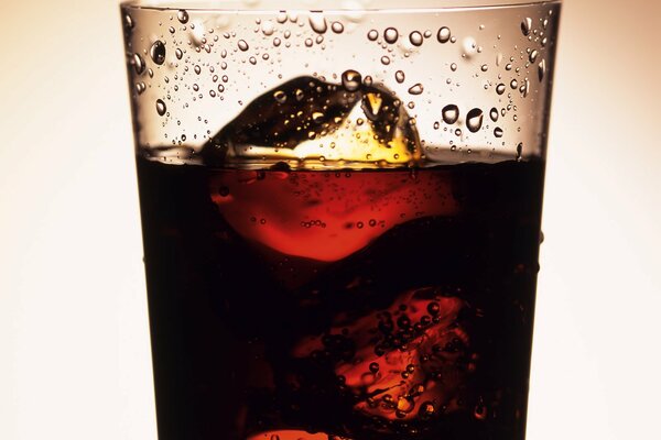 A glass of Coca-Cola drink with ice