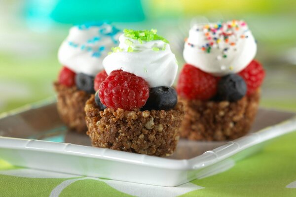 Sweet cakes with berries and cream