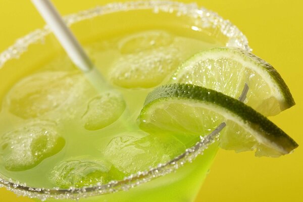 Drink in a glass with ice and lime slices