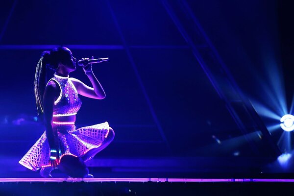 Singing sitting girl on stage