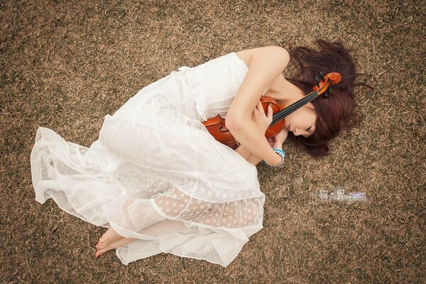 Hermosa chica en una corona con un violín