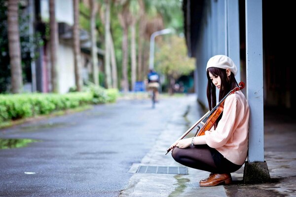 Fille avec violon assis