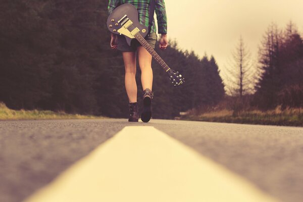 Art photos of a girl with a guitar behind her back