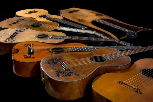 Lots of guitars on a black background