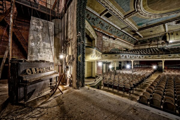 A large old hall with a piano on the stage