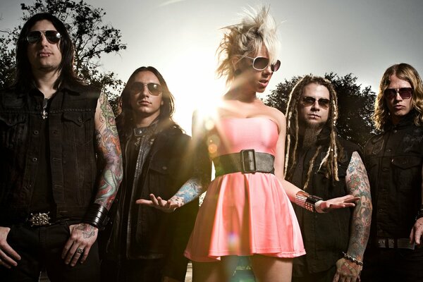 A girl with a mohawk surrounded by rockers