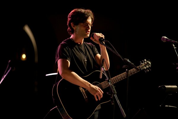 Artist Tim Buckley with guitar on stage