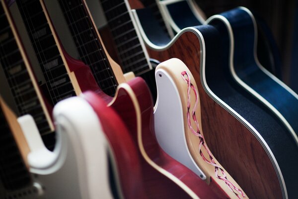 Many guitars of different colors