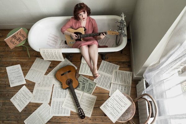 Girl playing guitar in the bathroom