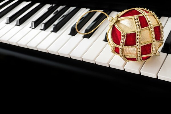 Christmas ball on the keys of a musical instrument