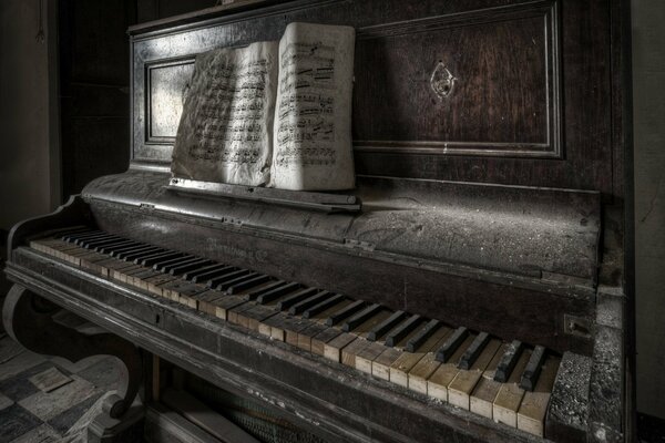 There is an old piano with yellowed notes