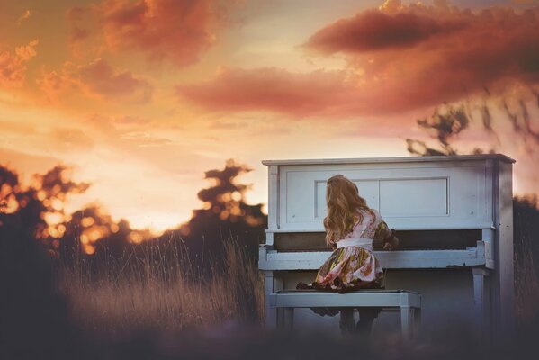 A girl playing the piano at sunset