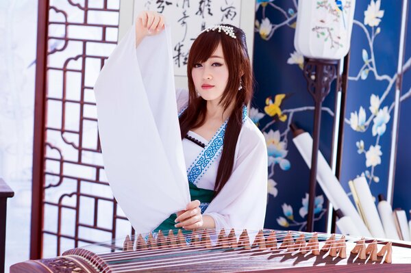 Asian girl in white with a musical instrument