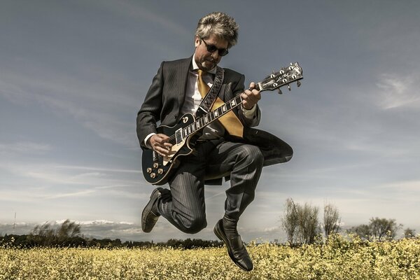 Un hombre con una guitarra en el campo