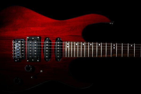 Red guitar on a black background