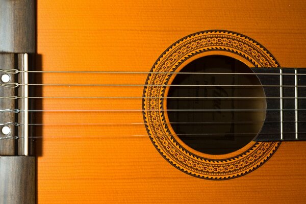 Tight strings of a yellow guitar