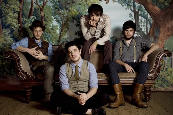 Four men from the group are sitting