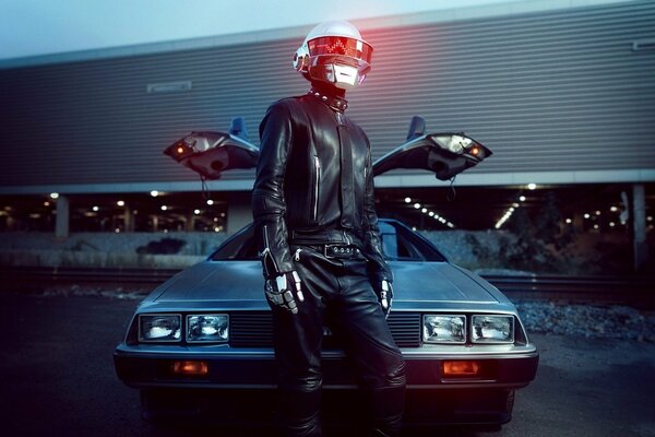 Daft Punk man in a glowing helmet on the background of a car