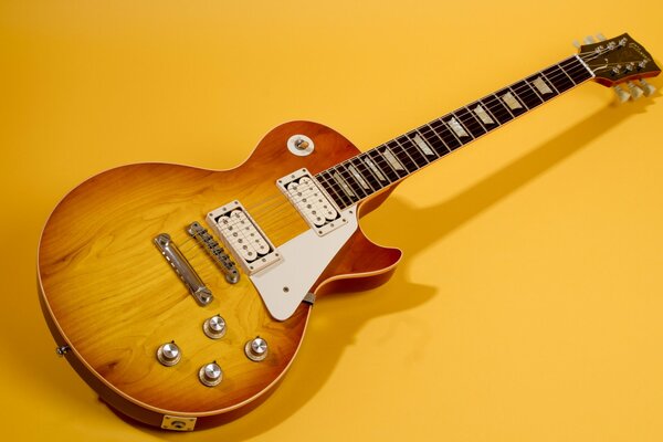 Gibson guitar 1960 on a yellow background