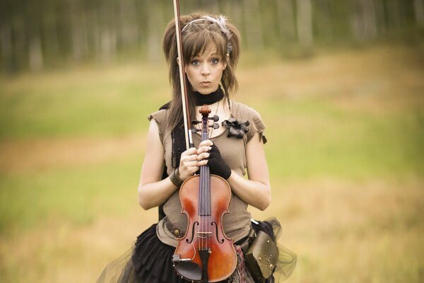 A girl in a field with a violin