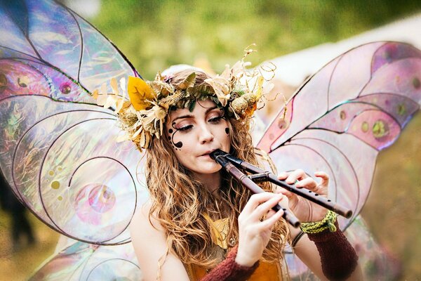 A girl in a butterfly costume with a flute