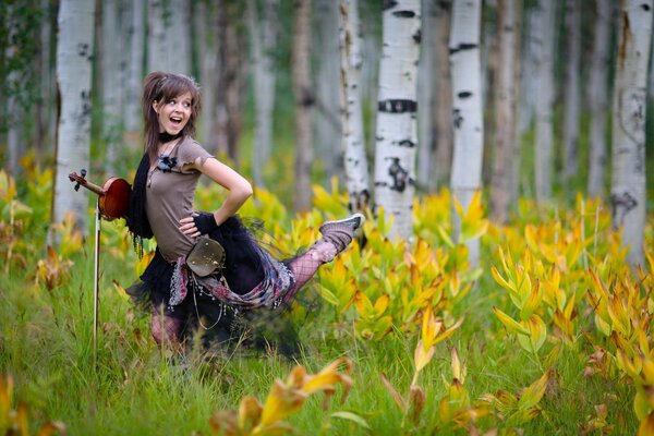 Dancing girl among the birches with a violin