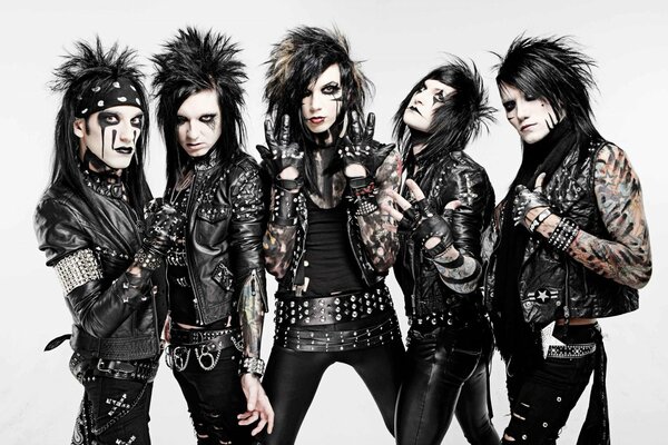 Heavy music group of five people in tattoos and bright makeup