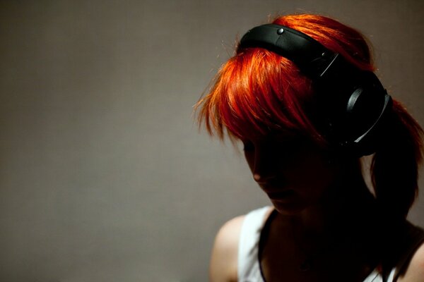 Red-haired girl with headphones