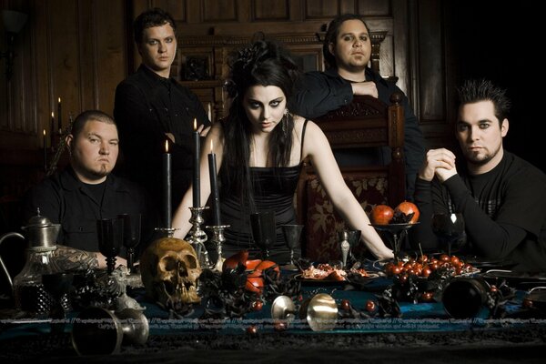 Evanescence group photo of the group at the table where the skull and treats