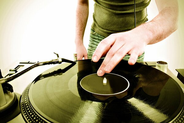 Mains d un DJ sur un disque vinyle