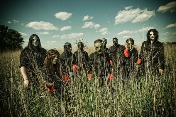 Slipknot band in a field against the sky