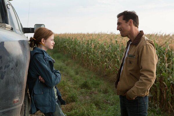 A red-haired girl with a smiling man