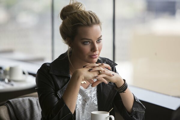 Beautiful Margot Robbie in a cafe