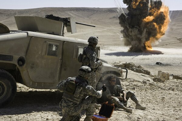 Soldiers hide behind the car and watch the explosion