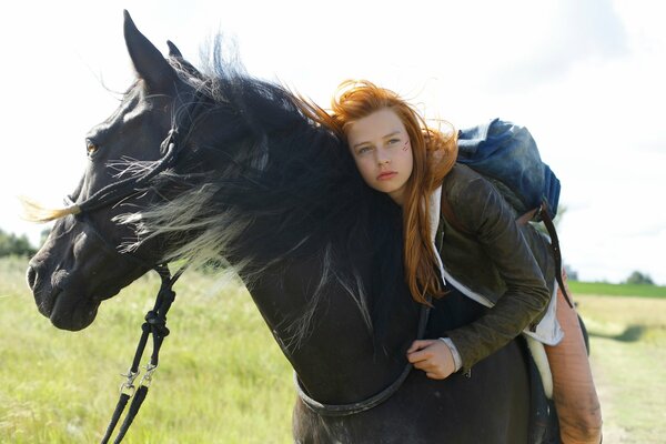 A girl with loose hair on a horse