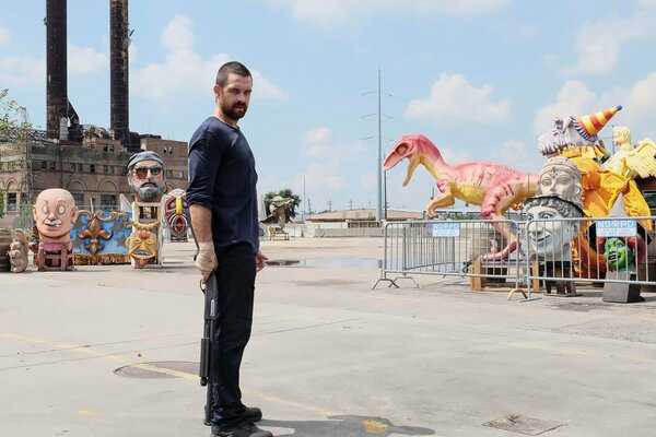 Anthony Starr with a gun on a children s attraction