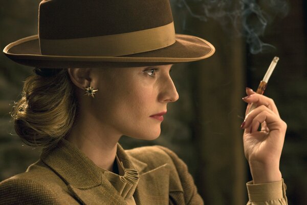 Diane Kruger in a hat and with a cigarette