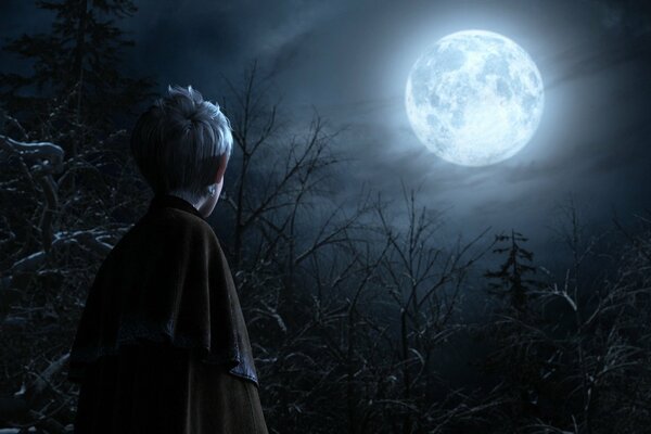 The image of a boy against the background of trees and the moon