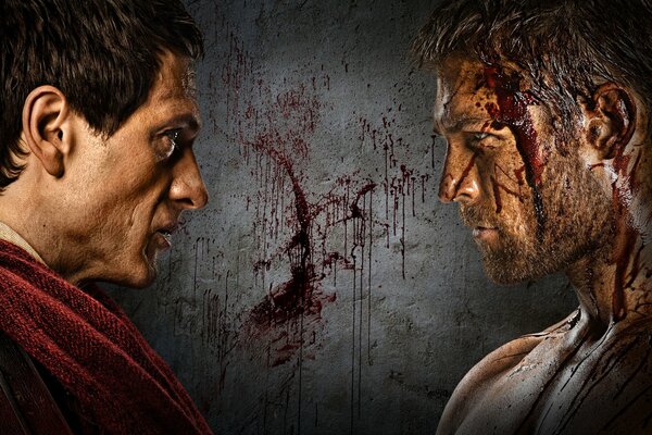 Two men look at each other against the background of a bloody wall