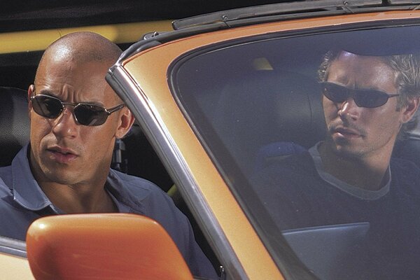 Two men in an orange car