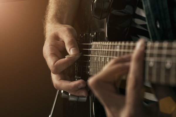 Photo in macro style: a man playing the guitar