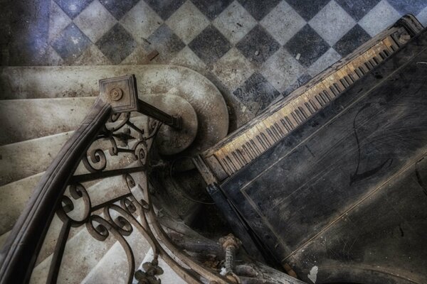 Stairs and a piano in an abandoned house